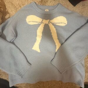 Blue Sweater with Cream Bow Design